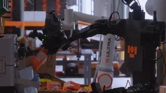 An Ultra robot Operator at work in a busy e-commerce warehouse